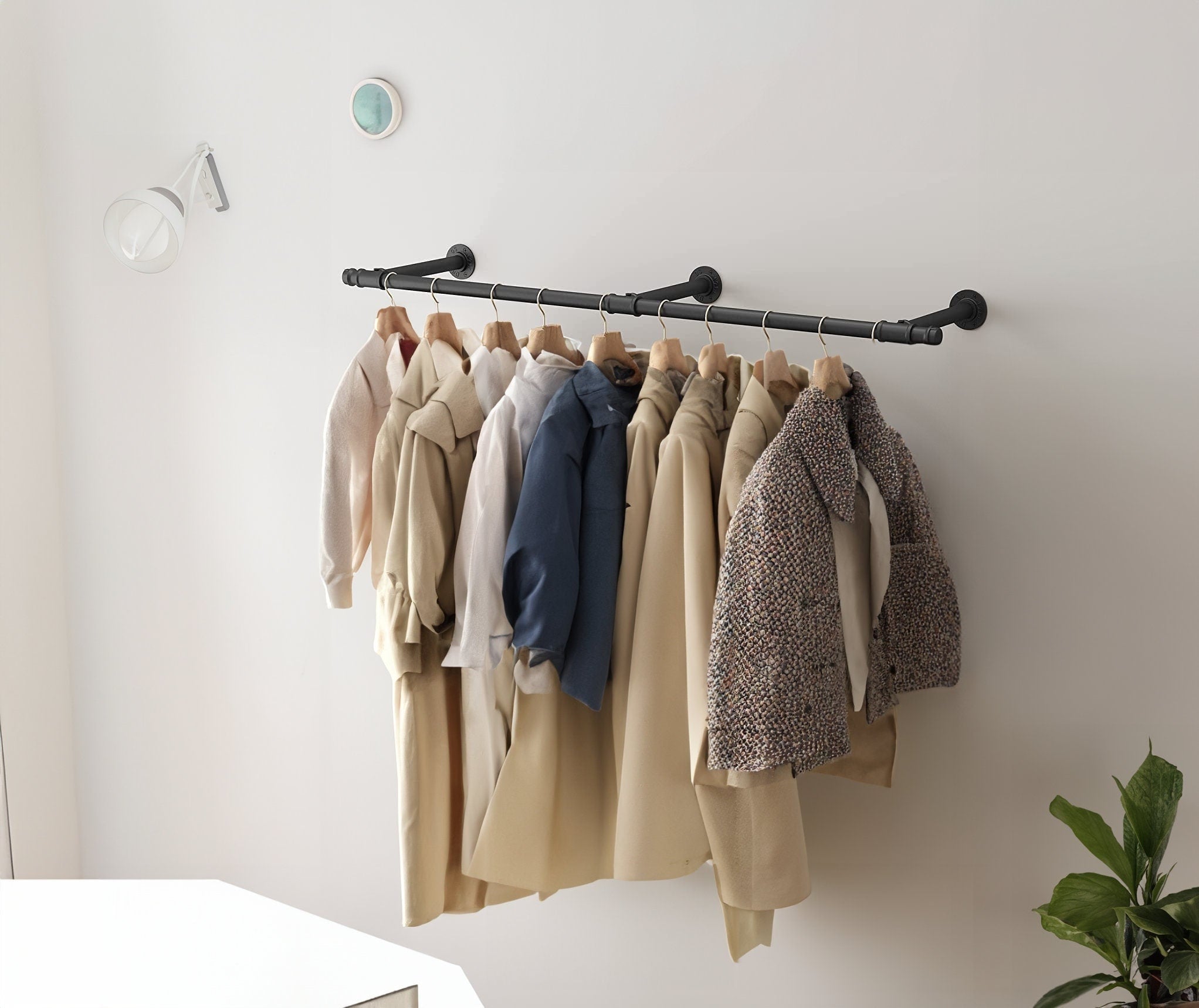 Retro wall-mounted hanging clothing rack, showcasing its design and capacity to hold many pieces of clothing.