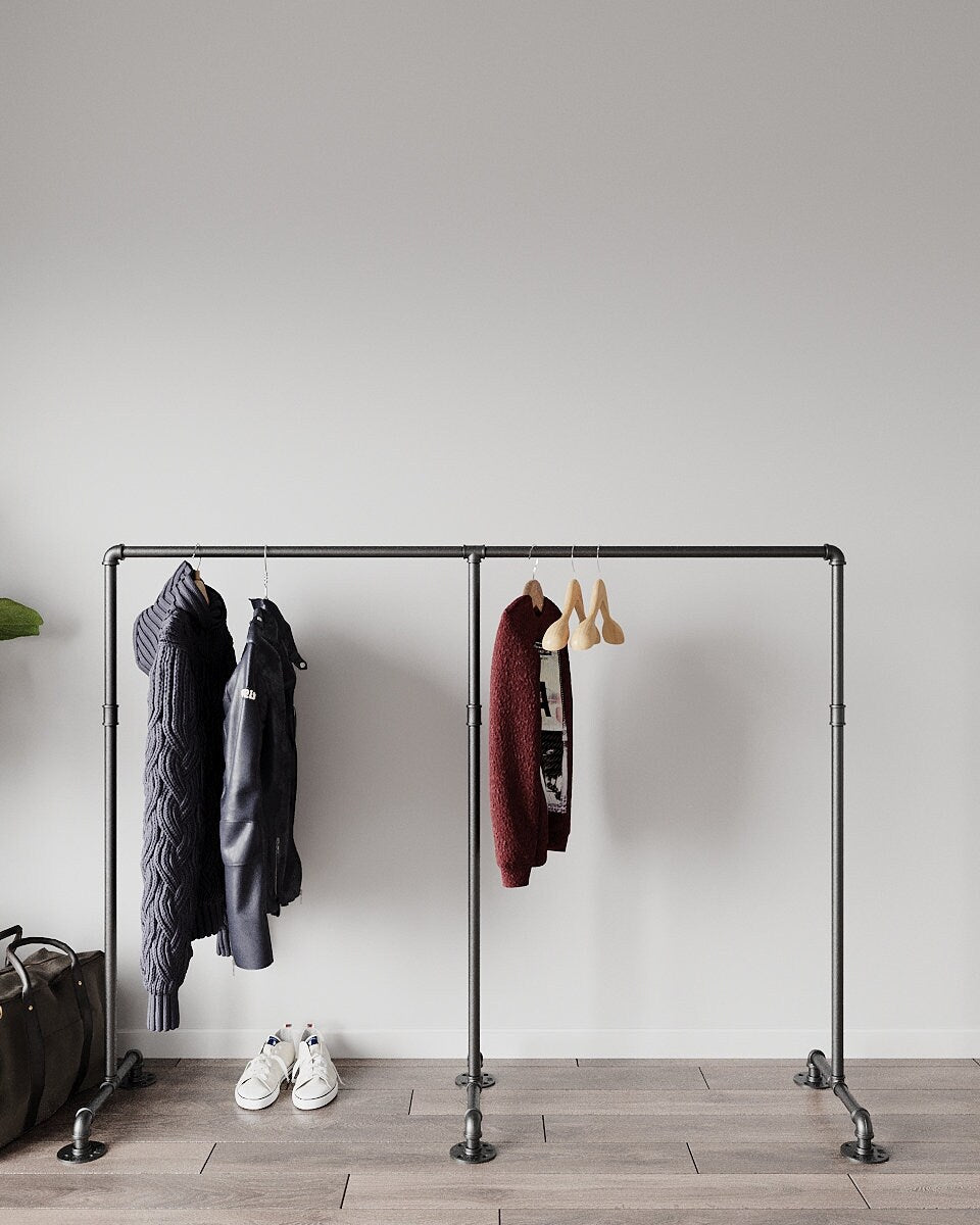Zing Minimalist Freestanding Pipe Clothes Rack, displaying hanging garments, showcasing its modern and minimalist design.