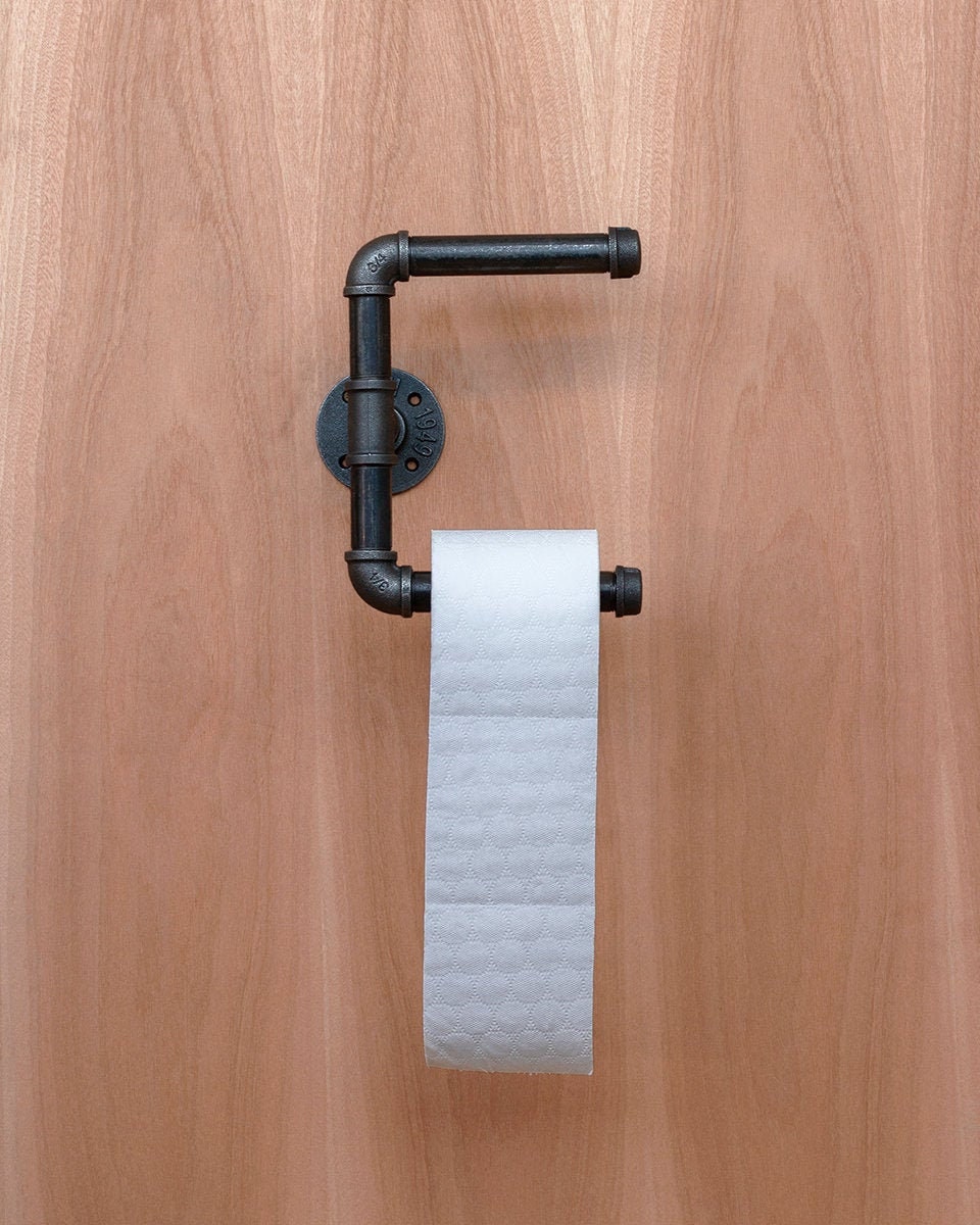 Toilet Roll Holder mounted on the wall, showcasing its sleek and practical design.