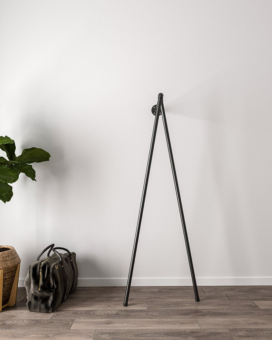 Iblu Clothes Rail, a wall-mounted and floor-supported industrial pipe clothes rail, showcasing its heavy-duty design."
