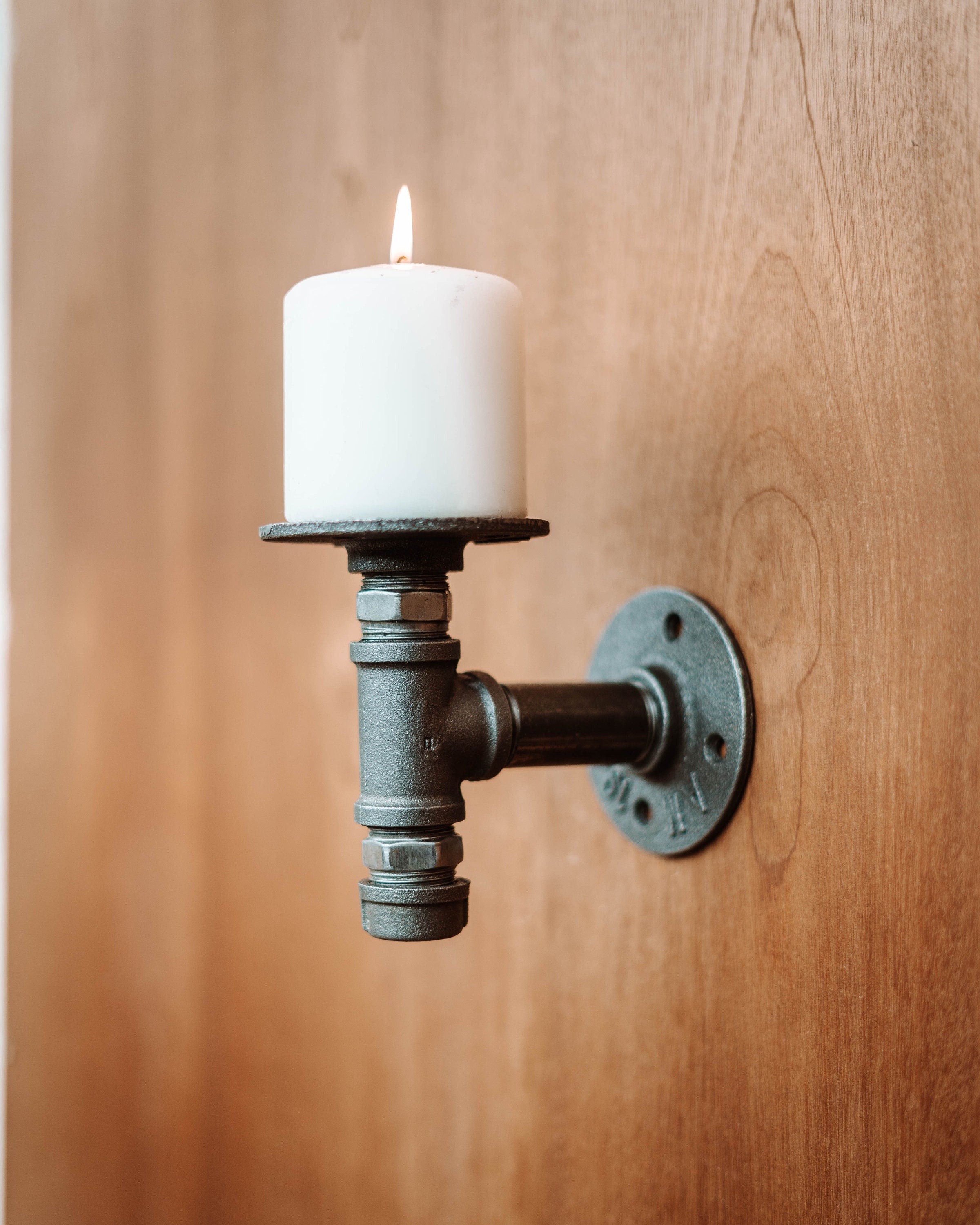 Wall Mounted Candle Holder with a candle plate, showcasing its elegant and sophisticated design.