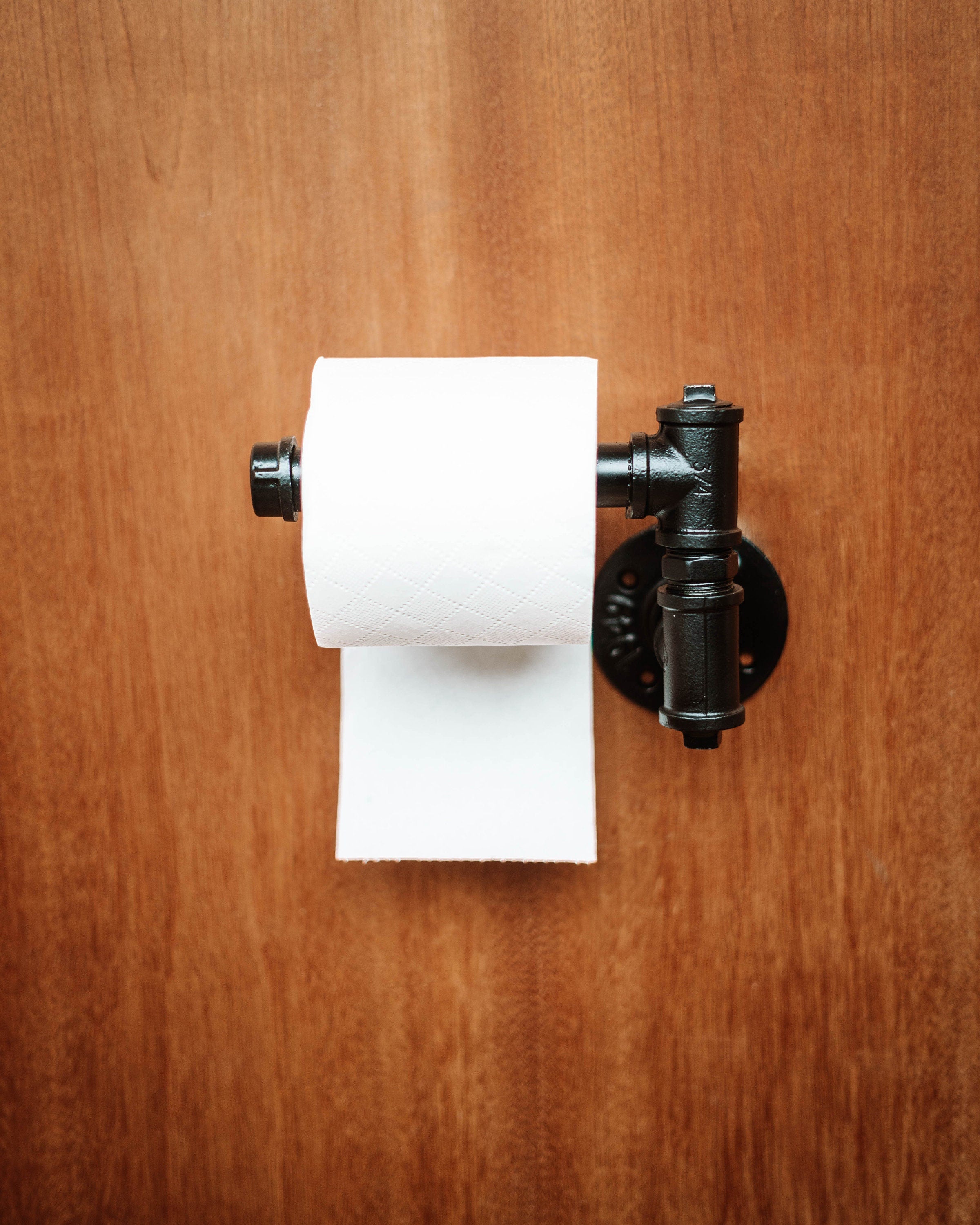 Modern Toilet Roll Holder supporting toiletroll, highlighting its practical and wall-mounted design