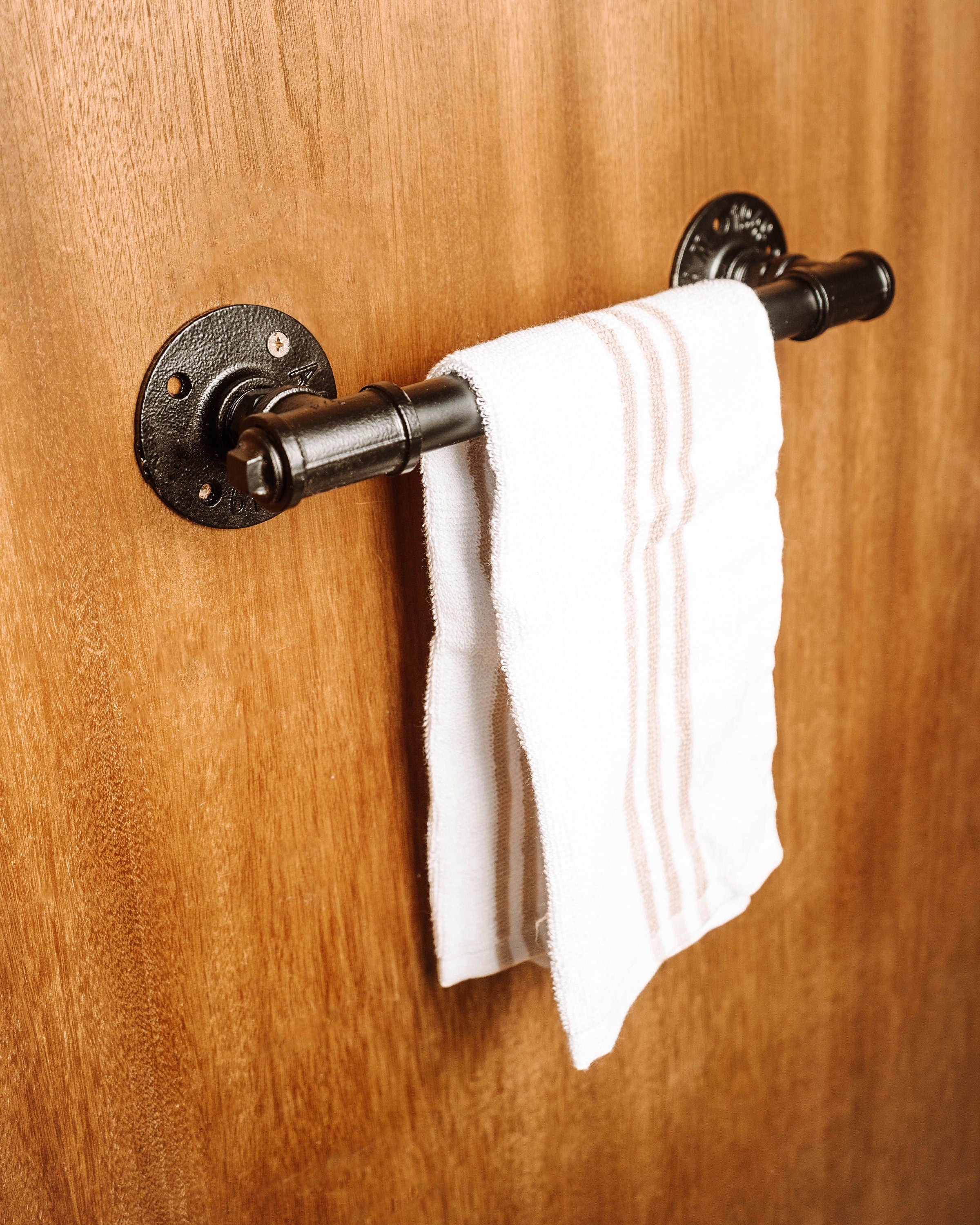 Wall Mounted Towel Holder Rack filled with towels, showcasing its versatile and space-saving design.