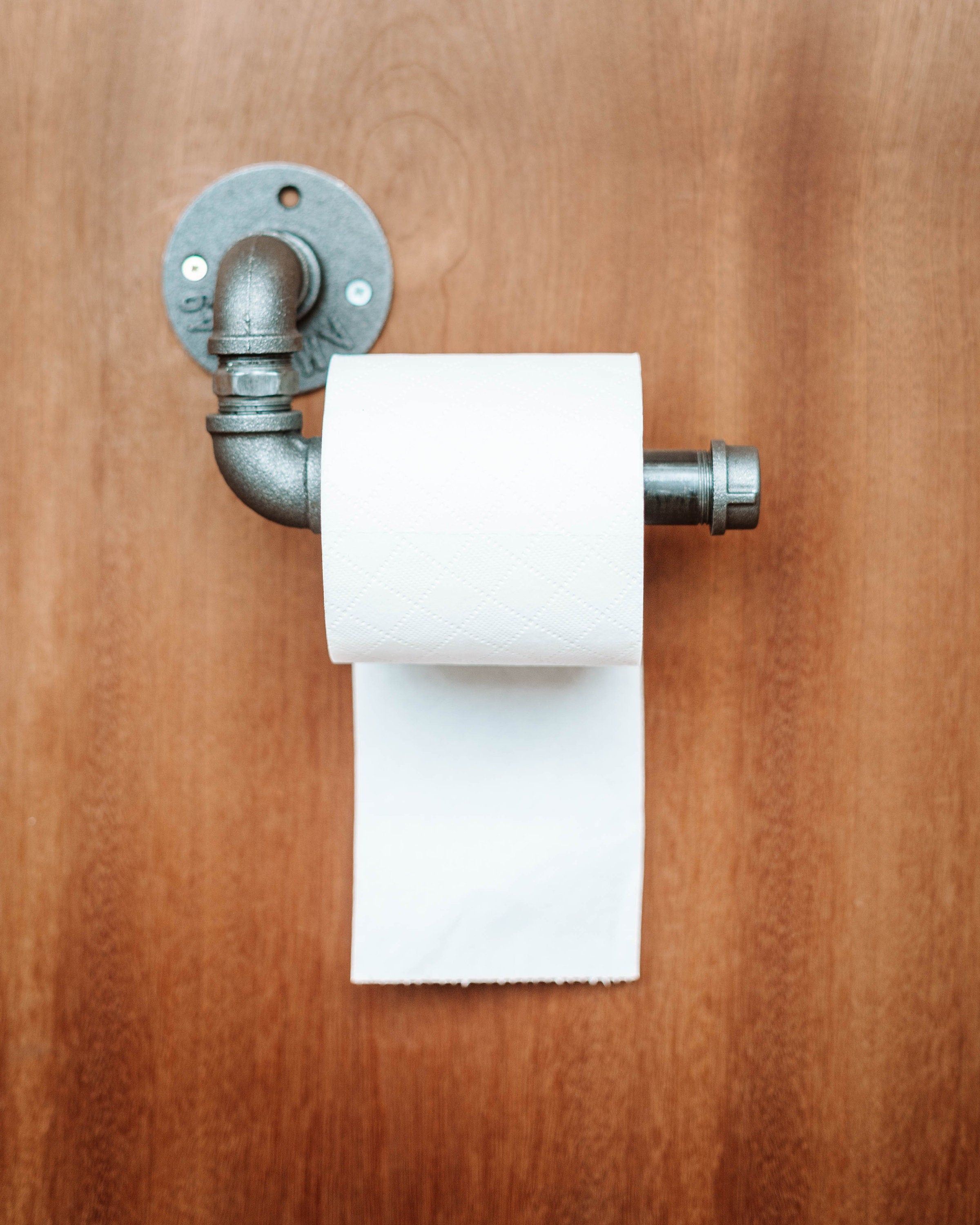 Toilet Roll Holder mounted on the wall, showcasing its sleek and practical design.