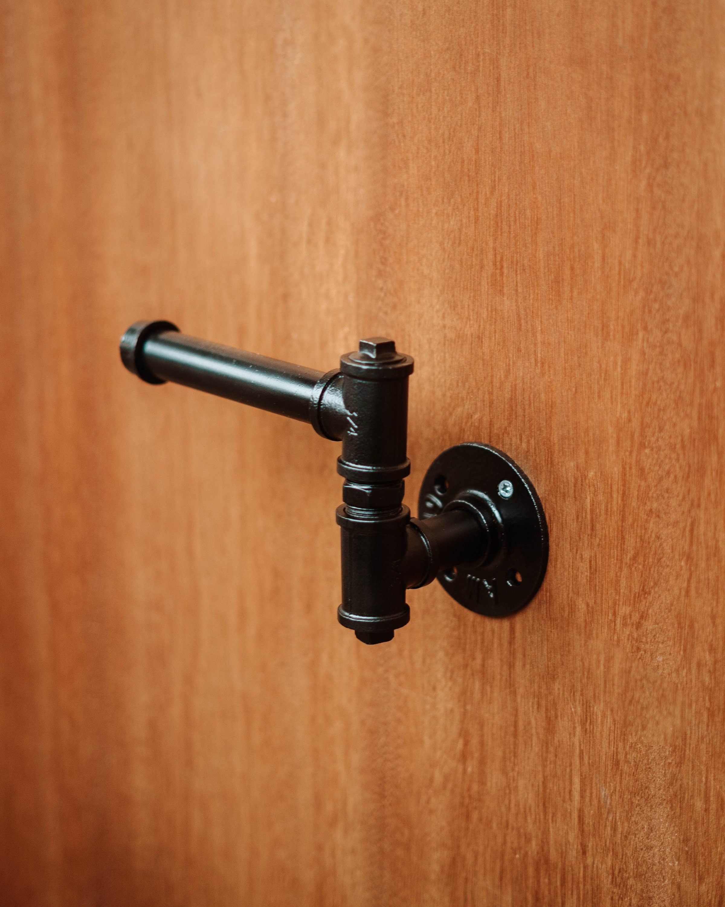 Modern Toilet Roll Holder supporting toiletroll, highlighting its practical and wall-mounted design