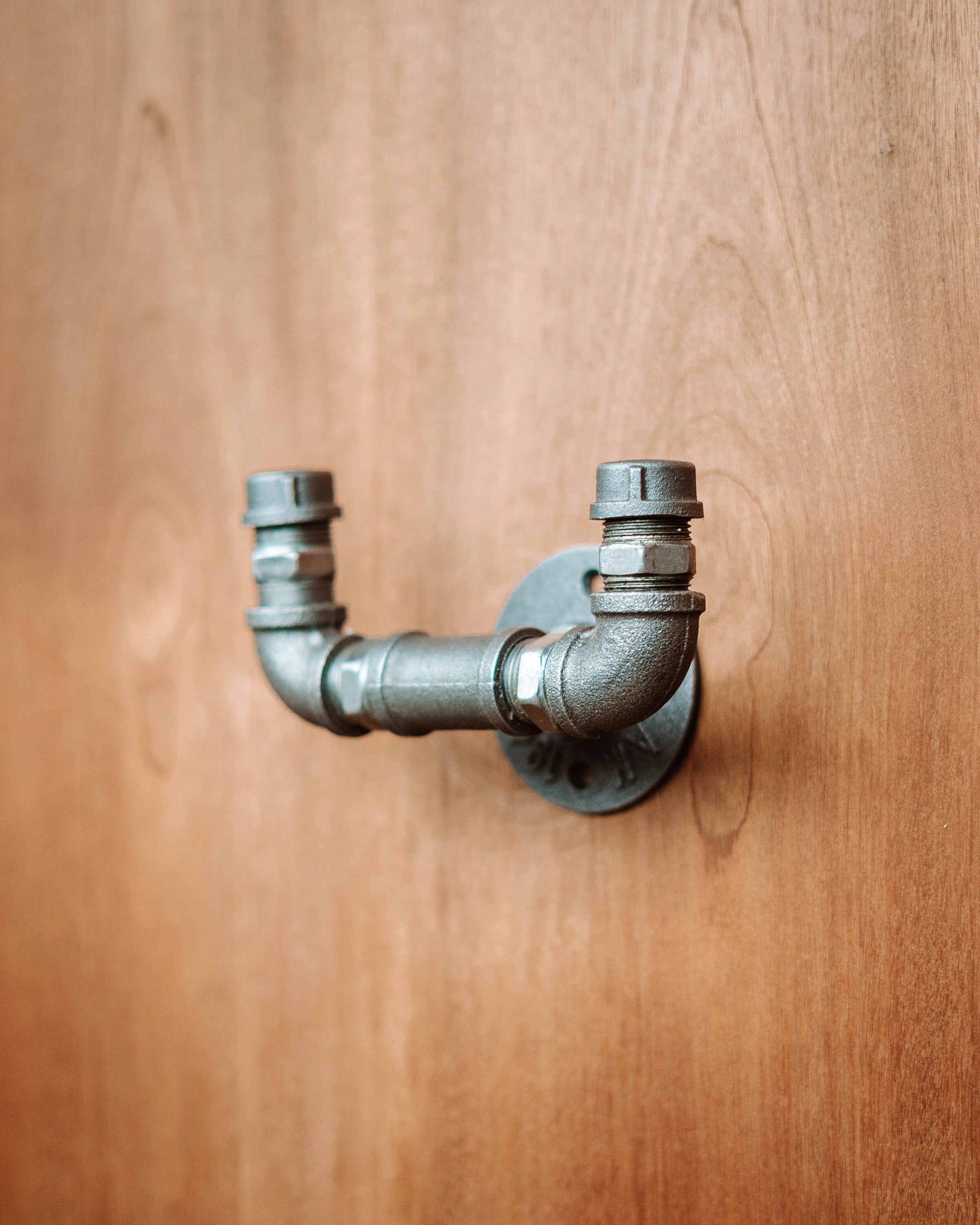 Industrial-style Pipe Coat Hanger Clothes Hook, ideal for organizing coats and accessories.