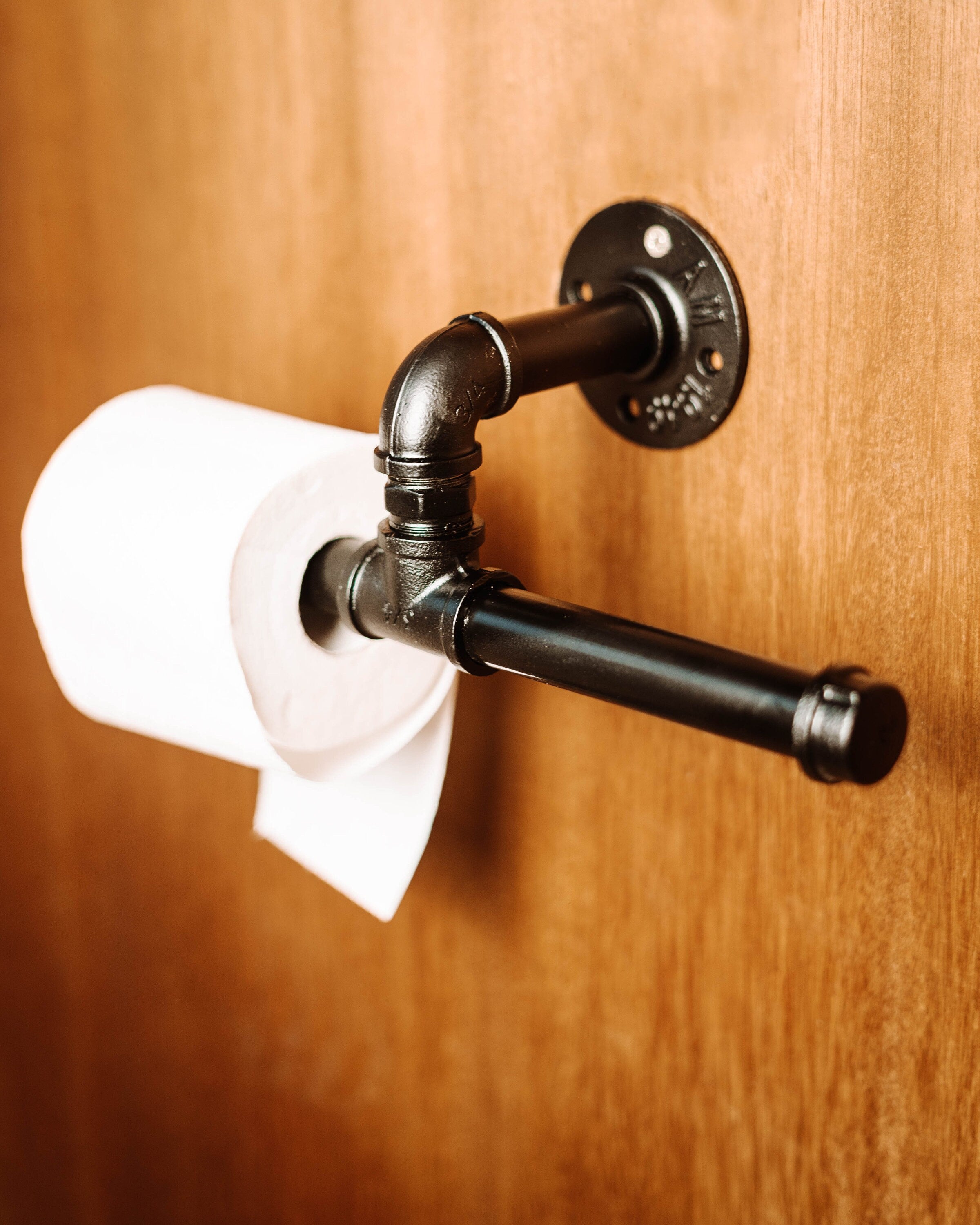 Toilet Roll Holder mounted on the wall, showcasing its sleek and practical design.