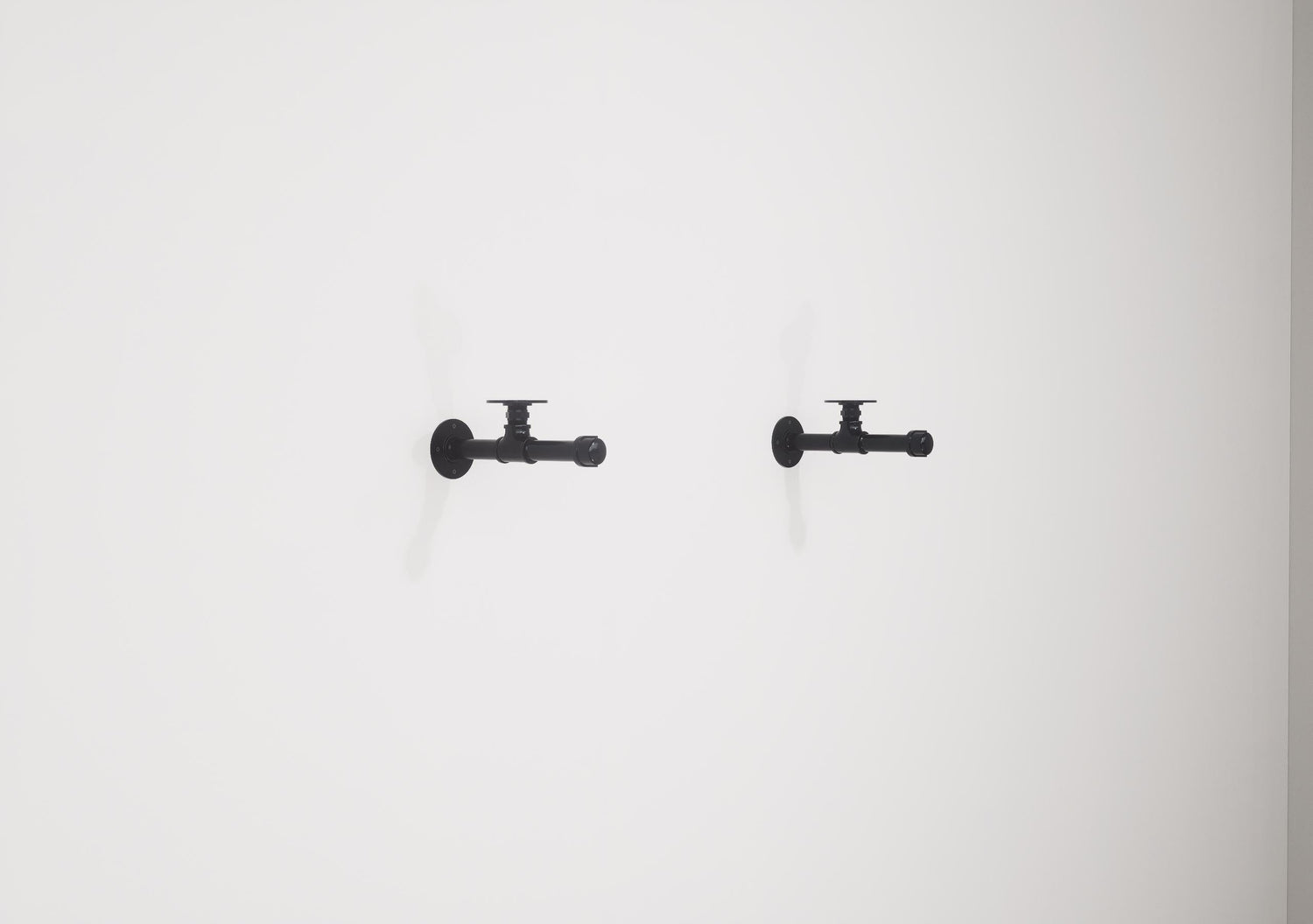 Wall-mounted industrial shelf with a wooden shelf and metal pipe fittings, featuring a hanging rail for clothes storage.