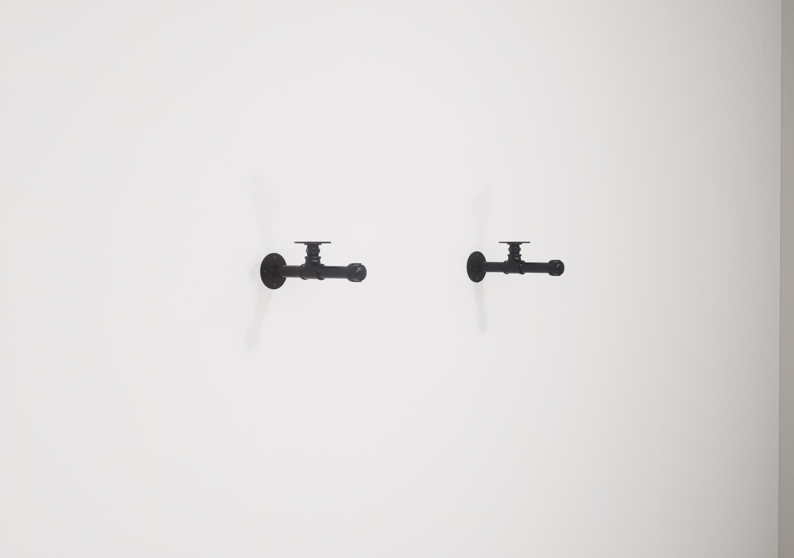 Wall-mounted industrial shelf with a wooden shelf and metal pipe fittings, featuring a hanging rail for clothes storage.