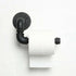 A black pipe-style toilet paper holder with a roll of white toilet paper attached to it, mounted on a white wall.