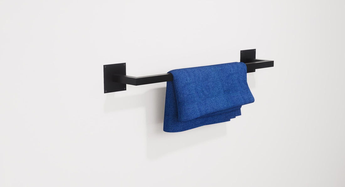 Minimalist square towel holder made from sturdy metal, featuring an industrial design. Ideal for organizing towels in the bathroom, adding a modern touch to decor. Durable and easy to install.