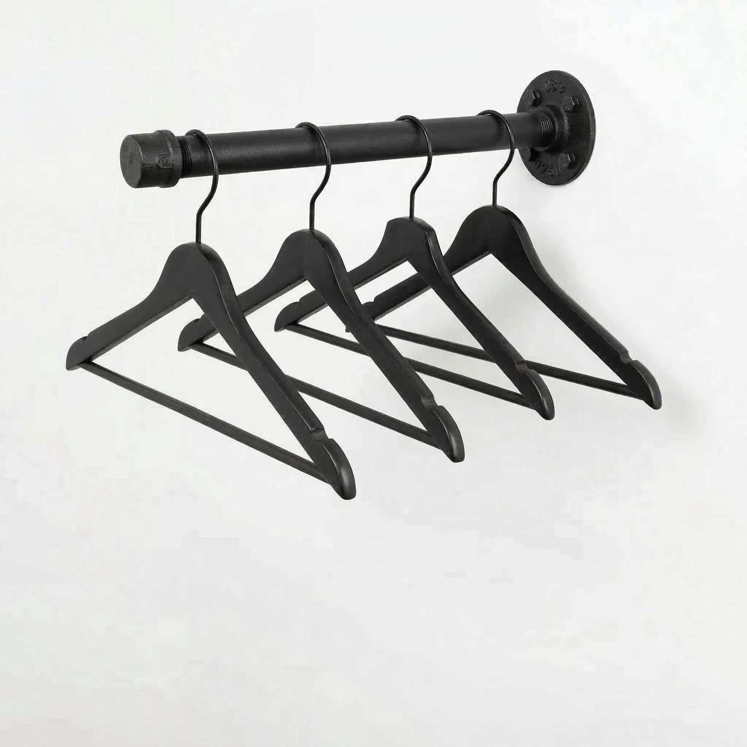 A black metal hanger rack with four black wooden hangers hanging from it.