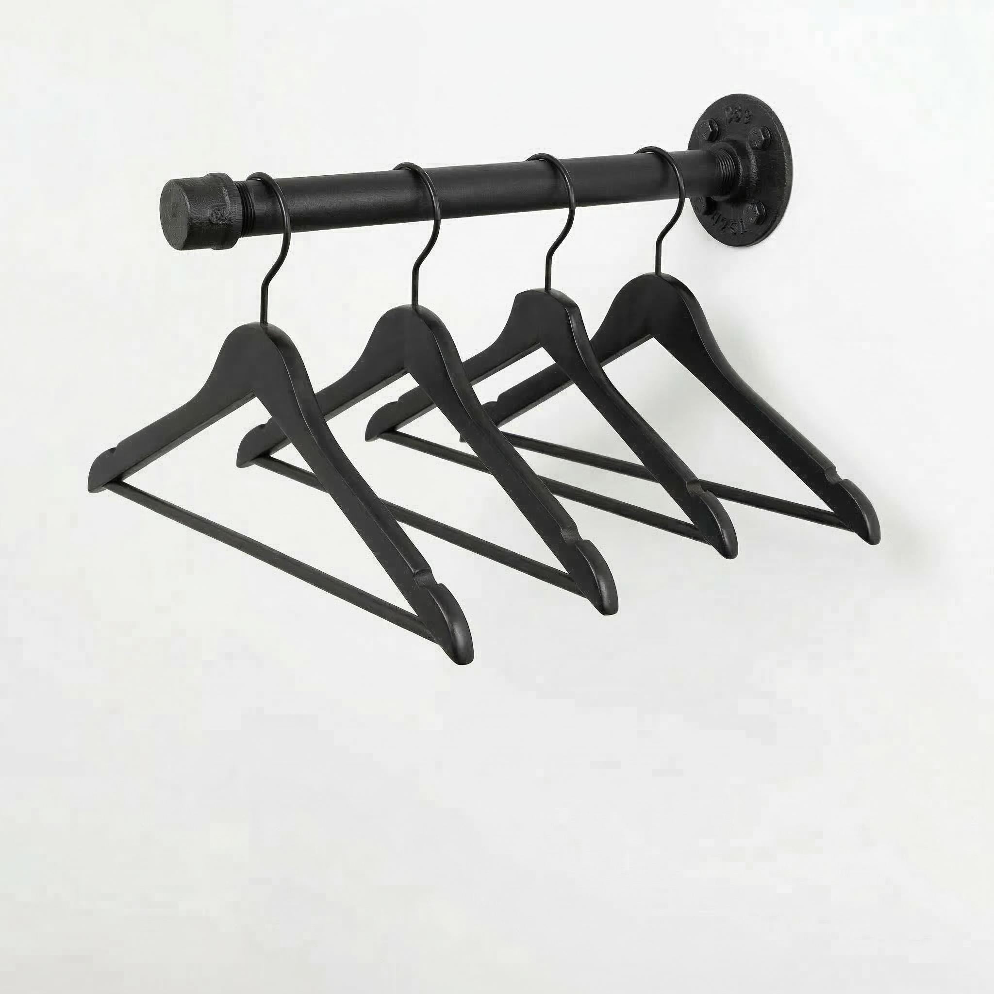 A black metal hanger rack with four black wooden hangers hanging from it.
