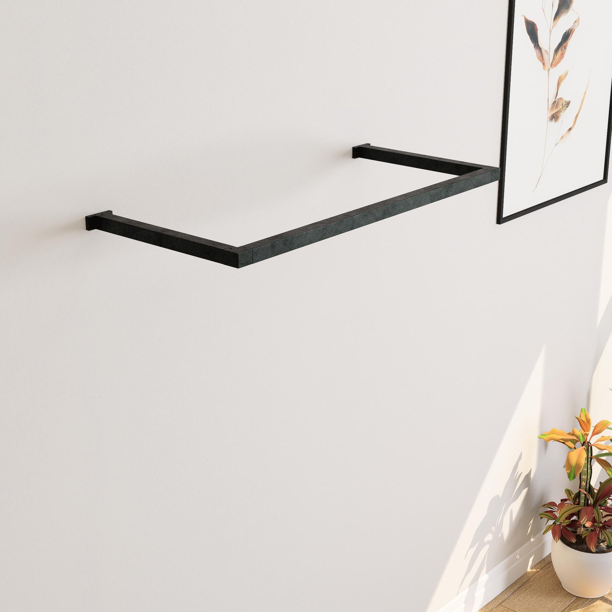 wall-mounted clothing rack with wooden hangers holding shirts and jackets, placed against a neutral wall with minimal decor.