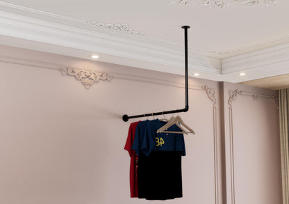a rack with clothes hanging from it in a room