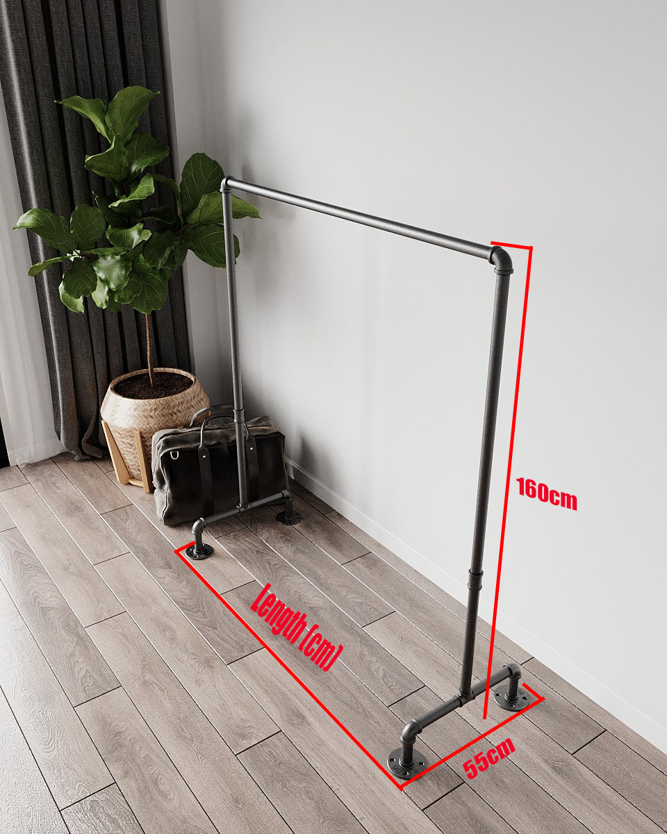 Estar Freestanding Pipe Clothes Rack, a robust and portable Open Wardrobe, suitable for hanging clothes and storing accessories in various aesthetic settings.