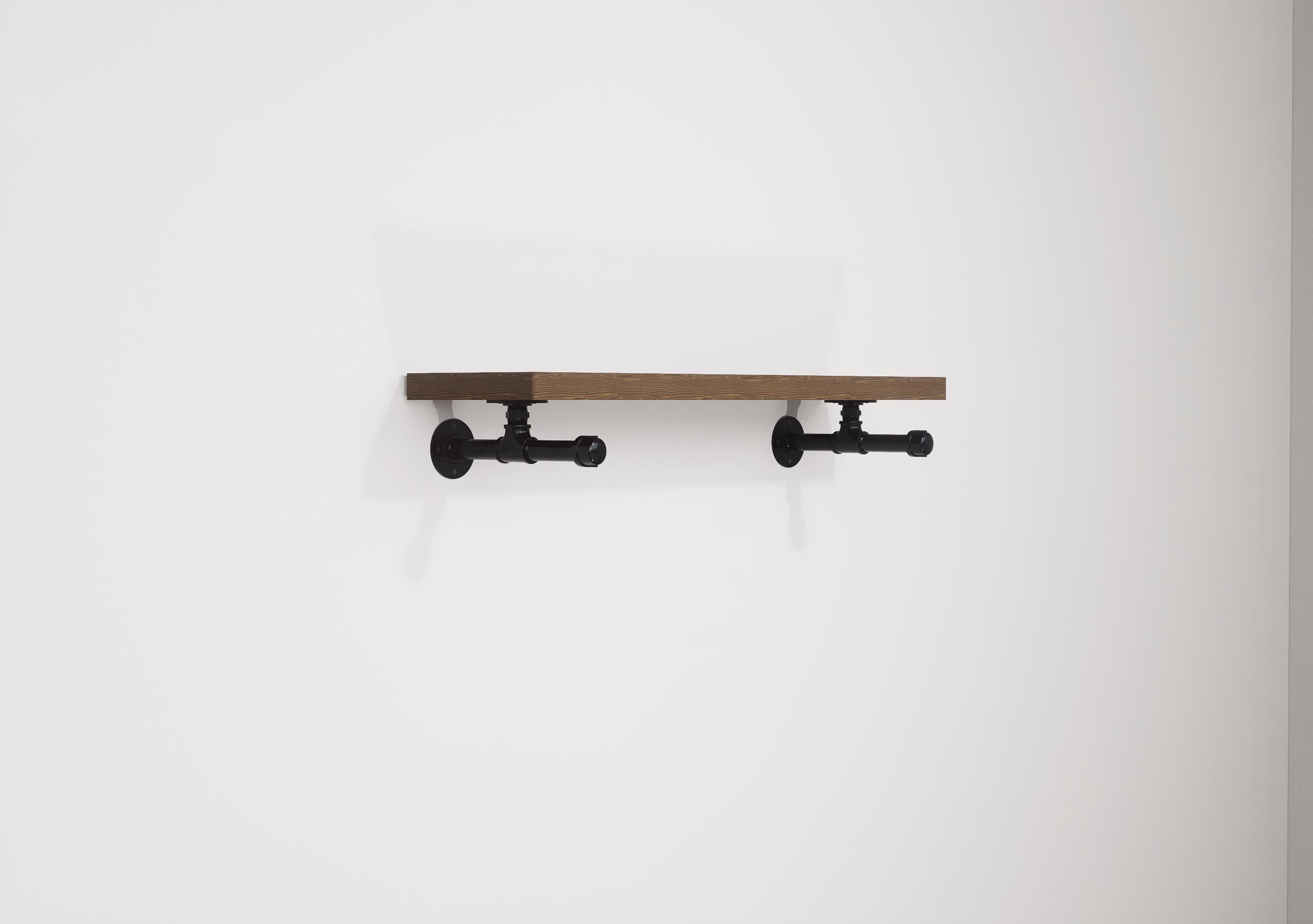 Industrial-style wall shelf with wooden top and metal hanging rail, perfect for organizing clothes and adding a rustic touch