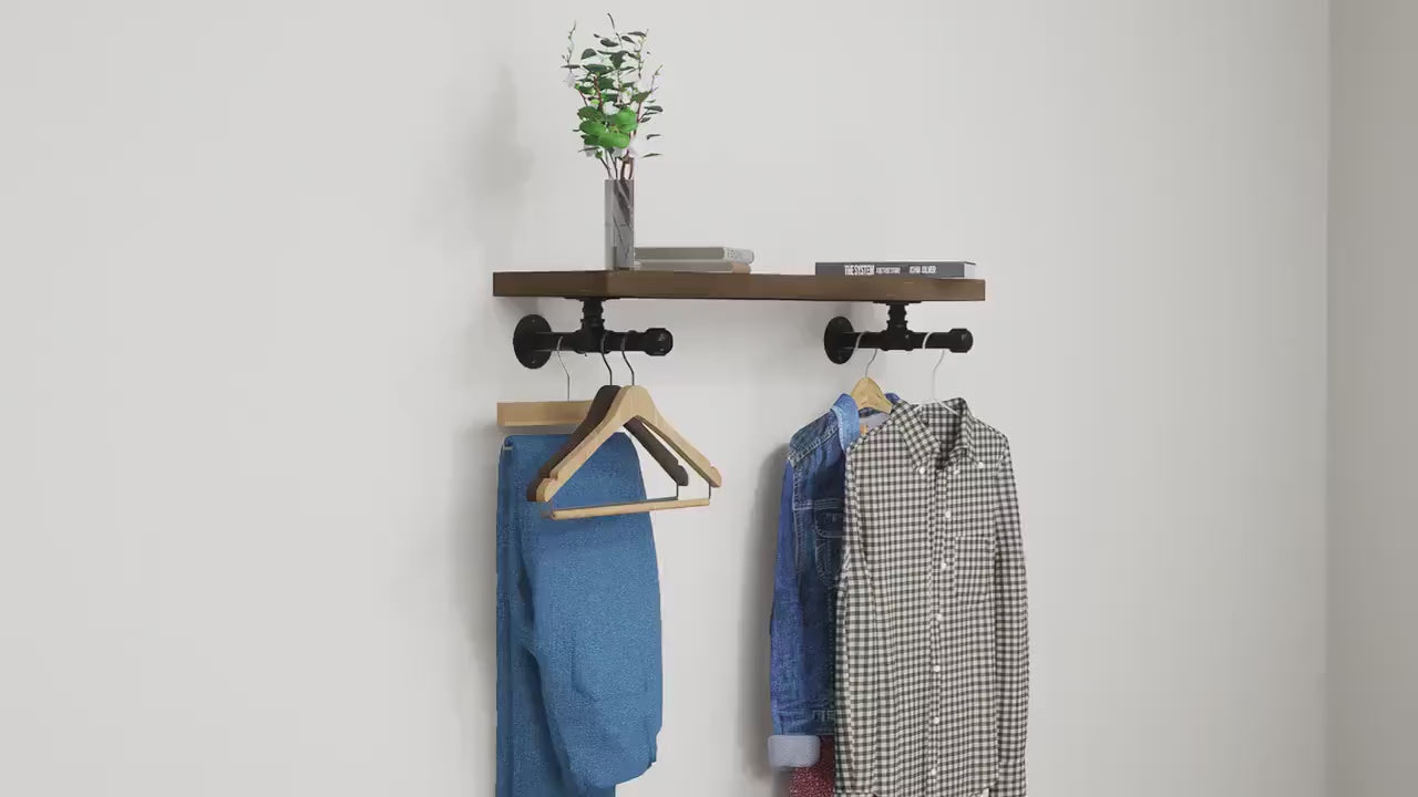 Wall-mounted industrial shelf with a wooden shelf and metal pipe fittings, featuring a hanging rail for clothes storage.