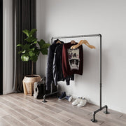 Portable and Collapsible Pipe Clothes Rail, a freestanding rack with hanging garments, highlighting its convenient and space-efficient design.