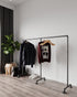 Zing Minimalist Freestanding Pipe Clothes Rack, displaying hanging garments, showcasing its modern and minimalist design.