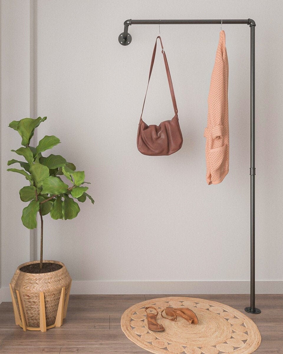 Clothes Rail, a wall-mounted and floor support rack, showcasing its modern pipe design