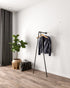 Iblu Clothes Rail, a wall-mounted and floor-supported industrial pipe clothes rail, showcasing its heavy-duty design."