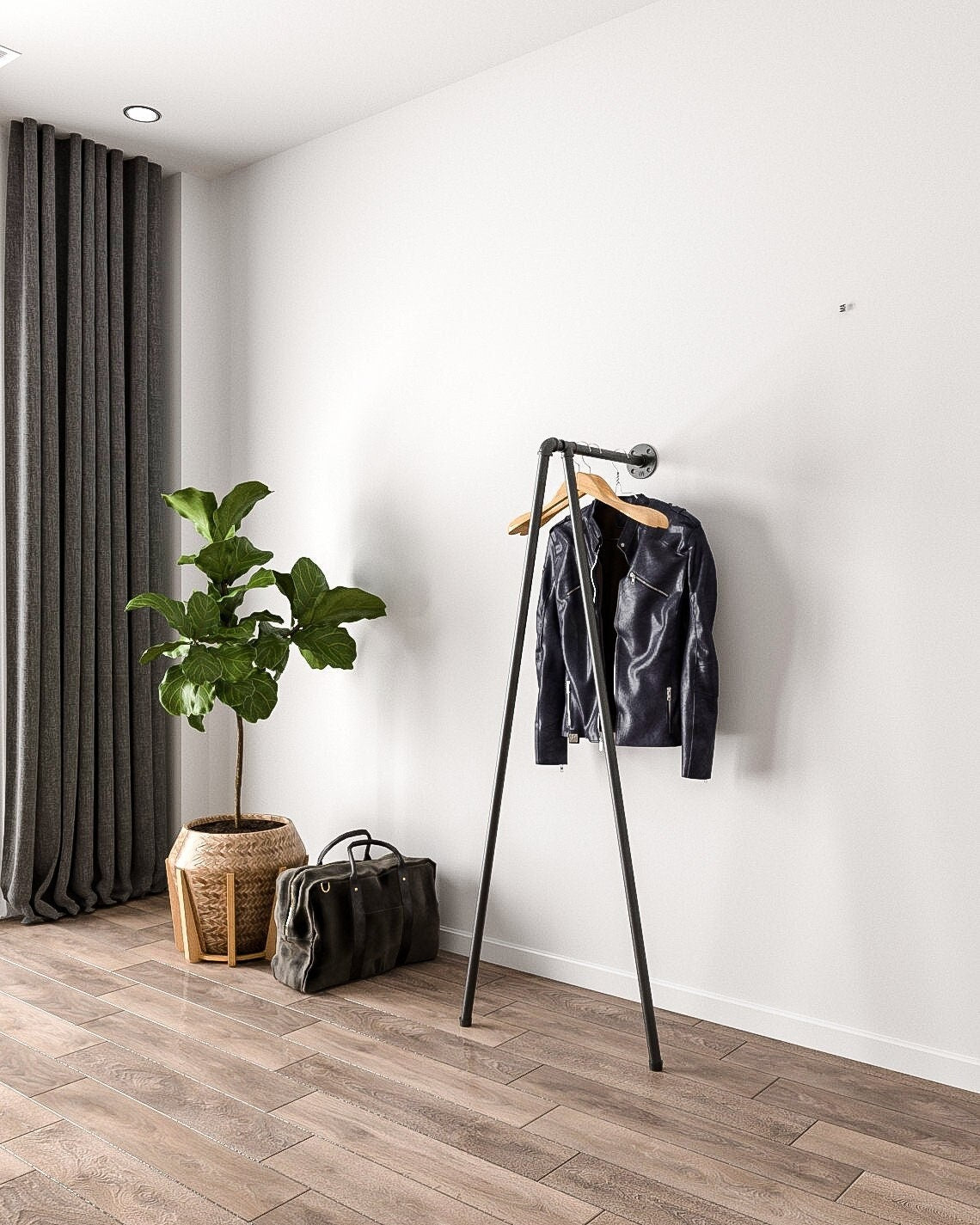Iblu Clothes Rail, a wall-mounted and floor-supported industrial pipe clothes rail, showcasing its heavy-duty design."