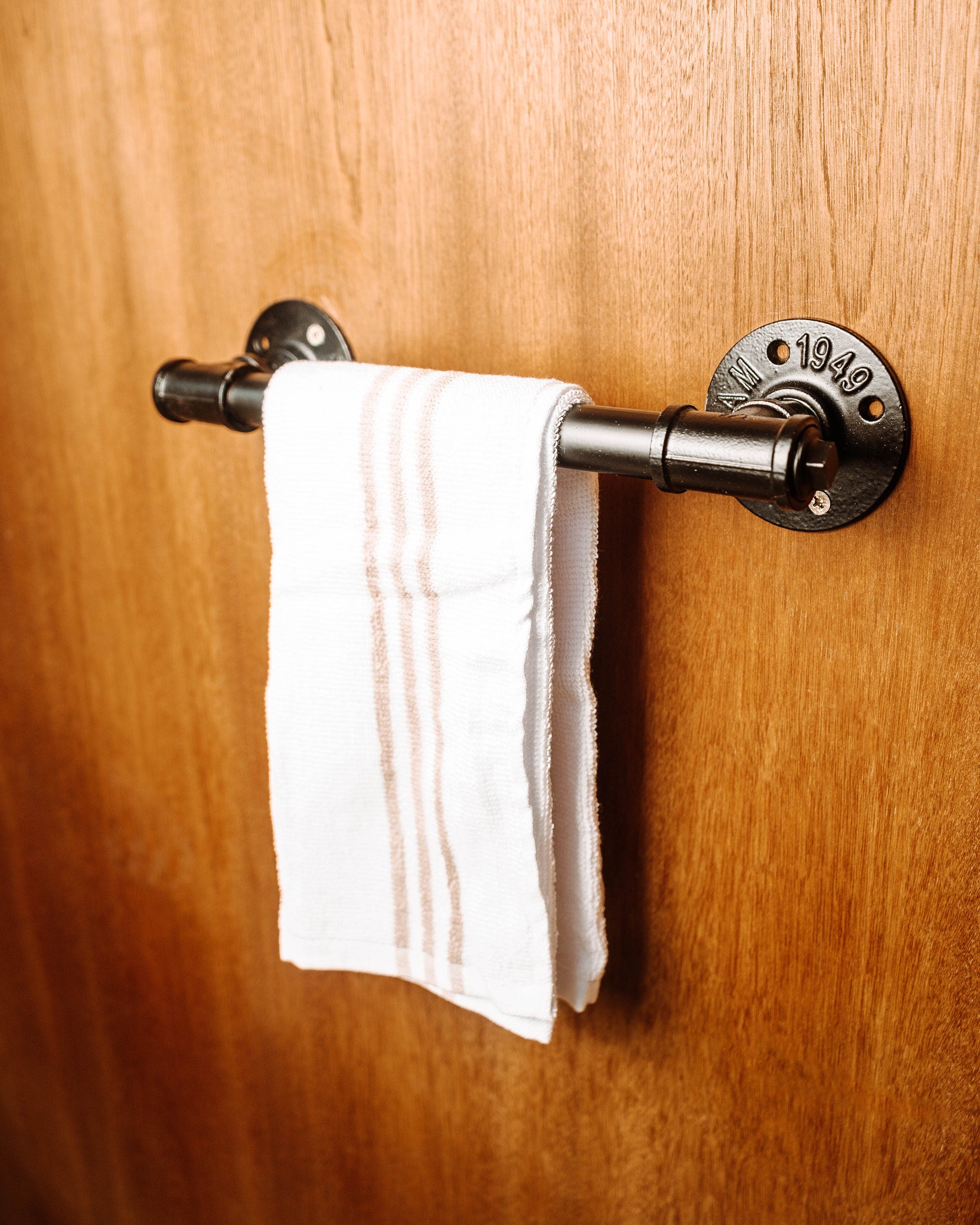 Wall Mounted Towel Holder Rack filled with towels, showcasing its versatile and space-saving design.