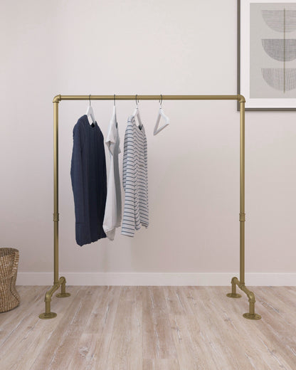 versatile Freestanding Pipe Clothes Rack made of gold rustic iron, filled with organized garments, showcasing its sturdy and unique design